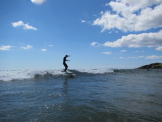 A surfer on a calm day, Bantham, Devon - 2015.